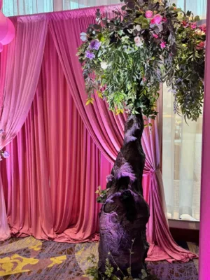 Quinceañera throne chair framed by pink curtains at Hilton BWI