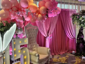 Floral centerpieces on pink linens at the quinceañera in BWI, MD