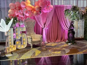 Close-up of roses and glass vases at the quinceañera in BWI