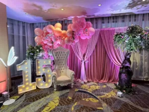 Table settings with pink florals at the quinceañera in BWI, MD