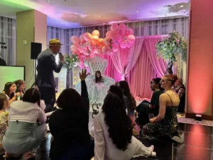 Tiered cake display with pink flowers at the BWI quinceañera