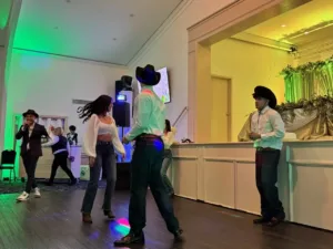 Couple dancing with emcee and guests at Jimena's quinceañera in Silver Spring, MD