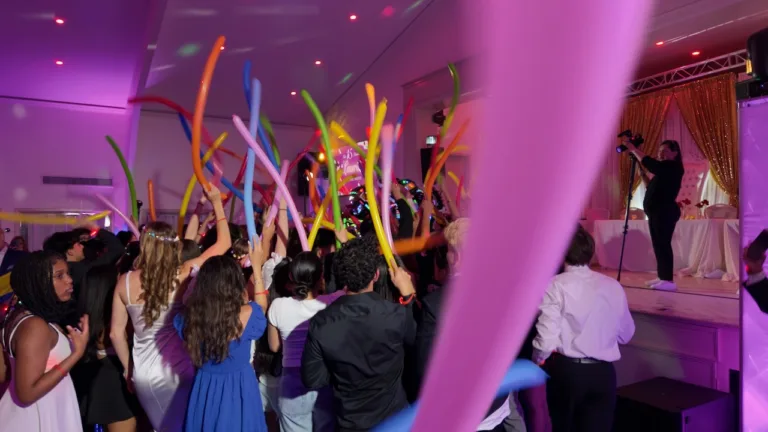 Purple draped ceiling with colorful hanging lights at Laura's quinceañera in Silver Spring, MD