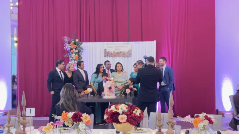 Pink draped backdrop with festive lighting for Moina Banerjee's 70th birthday at Bethesda Marriott in Bethesda, MD